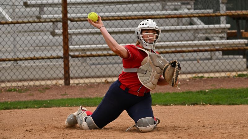 Softball catcher throwing the ball back to pitcher